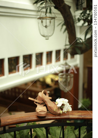 Stylish and highly fashionable woman high heeled shoes with trendy accessories, captured on a colorful background, exuding luxury and elegance perfect for wedding or formal outfit inspiration Stylish and highly fashionable woman high heeled shoes with trendy accessories, captured on a colorful background, exuding luxury and elegance perfect for wedding or formal outfit inspiration 134780501