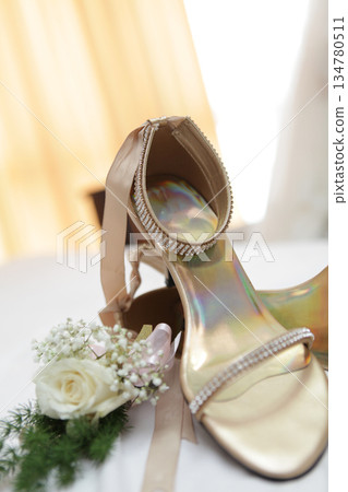 Stylish and highly fashionable woman high heeled shoes with trendy accessories, captured on a colorful background, exuding luxury and elegance perfect for wedding or formal outfit inspiration 134780511