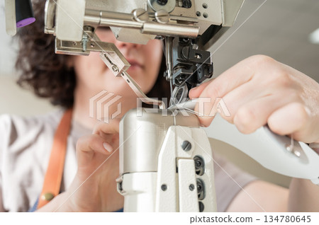 Woman tanner at work in the workshop. Woman tanner at work in the workshop. 134780645
