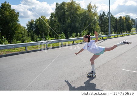 Caucasian woman in shorts roller skating. Caucasian woman in shorts roller skating. 134780659