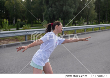 Caucasian woman in shorts roller skating.  134780665
