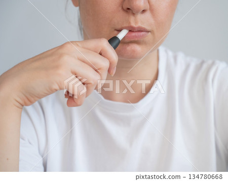Woman smoking tobacco heating system. Electronic cigarette. Woman smoking tobacco heating system. Electronic cigarette. 134780668