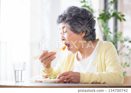 Senior woman to eat Senior woman to eat 134780742