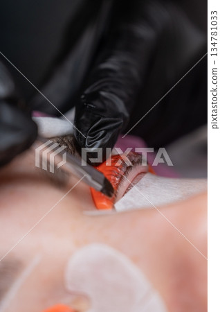 Caucasian woman undergoing eyelash lamination procedure.  134781033