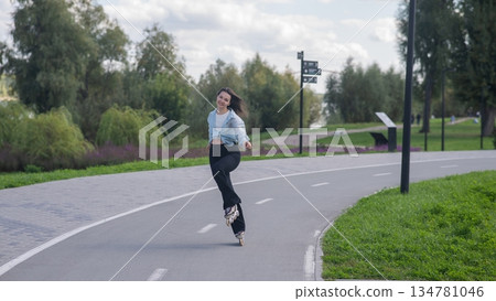 Caucasian woman roller skating in park.  134781046