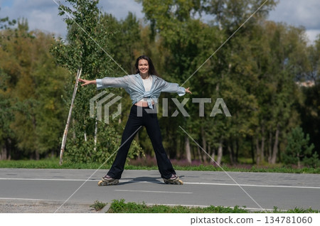 Caucasian woman roller skating in park. Caucasian woman roller skating in park. 134781060