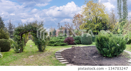 Winding Stone Path Among Tall Pine Trees In Autumn Garden 134783247
