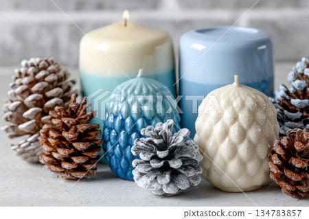 Decorative candles and pine cones arrangement 134783857