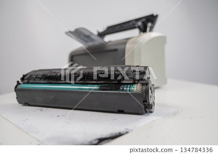 Broken laser printer cartridge on white background. Broken laser printer cartridge on white background. 134784336