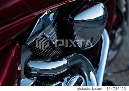 Close up of the stunning engine and exhaust pipe of the red motorcycle. Close up of the stunning engine and exhaust pipe of the red motorcycle. 134784423