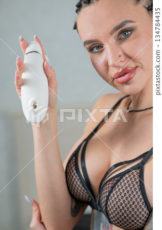Caucasian woman holding a vacuum vibrator.  134784435