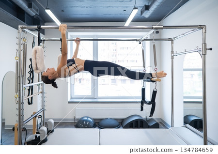 Caucasian woman doing pilates on reformer.  134784659