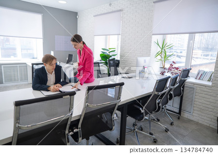 Caucasian woman giving instructions to subordinate.  134784740