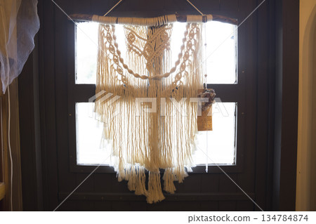 Macrame tapestries displayed at the store entrance 134784874