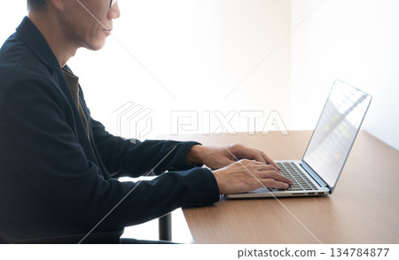 Man using a computer Man using a computer 134784877
