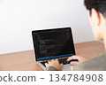 Back view of a man programming 134784908
