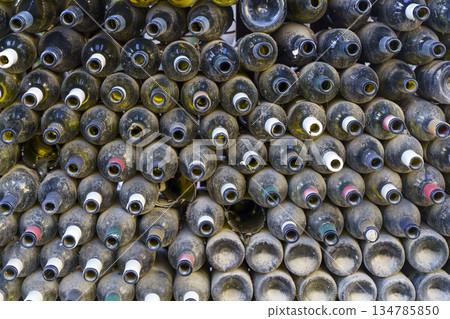 Rows of Dusty Empty Wine Bottles in a Dark Cellar or Warehouse. High quality photo 134785850