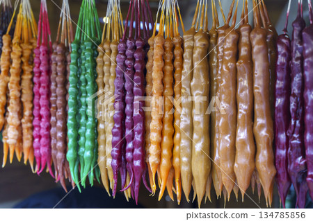 Traditional Georgian Churchkhela Sweets Hanging in a Row at a Market. High quality photo Traditional Georgian Churchkhela Sweets Hanging in a Row at a Market. High quality photo 134785856