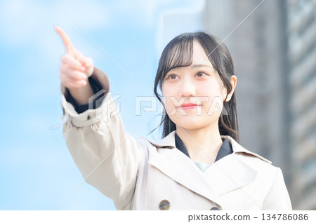 Woman pointing in an office district Woman pointing in an office district 134786086