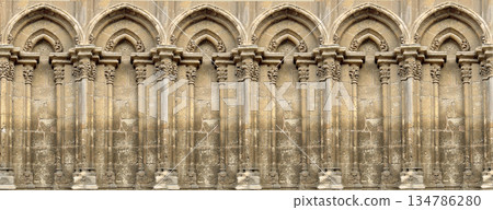 Stone facade with multiple arches and classic columns 134786280