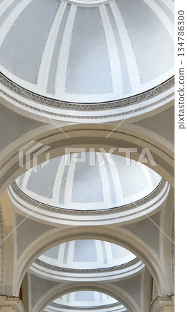 Repetitive neoclassical architecture creating symmetrical ceiling domes 134786300