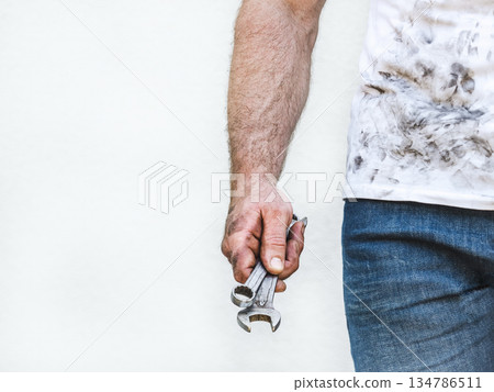 Attractive man, hand tools and dirty shirt 134786511