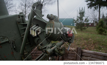 close-up artillery mechanism gears and cables, weathered metal shows maintenance marks and red inspection close-up artillery mechanism gears and cables, weathered metal shows maintenance marks and red inspection 134786871