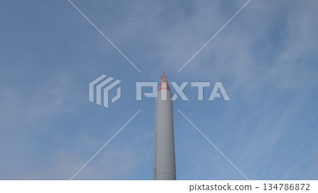 tall rocket monument pointing into sky, red-tipped nose and smooth steel casing, frontal vertical perspective tall rocket monument pointing into sky, red-tipped nose and smooth steel casing, frontal vertical perspective 134786872