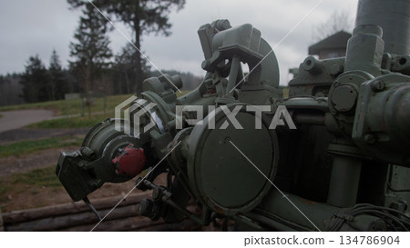 close-up artillery breech showing mechanical detail and painted surfaces; restorer inspecting corrosion close-up artillery breech showing mechanical detail and painted surfaces; restorer inspecting corrosion 134786904
