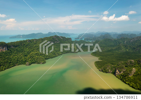 Scenic view of the green mountains and the river in KILIM Park on a sunny day with a clear sky. Langkawi Island. Malaysia Scenic view of the green mountains and the river in KILIM Park on a sunny day with a clear sky. Langkawi Island. Malaysia 134786911