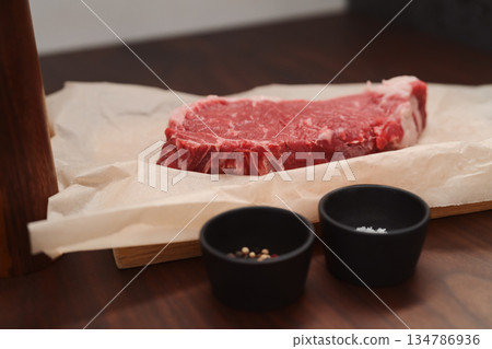 raw new york steak on walnut wood background with copy space 134786936