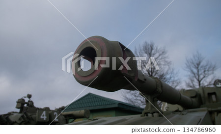 angled tank barrel cutting into bright sky, clean silhouette emphasizes line and form with soft cloud texture, angled tank barrel cutting into bright sky, clean silhouette emphasizes line and form with soft cloud texture, 134786960