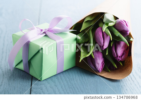 purple tulips with gift box on blue wood background purple tulips with gift box on blue wood background 134786968