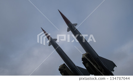 twin interceptors on launcher against moody sky, strategic deterrent vibe with sharp red tips and vertical twin interceptors on launcher against moody sky, strategic deterrent vibe with sharp red tips and vertical 134787044