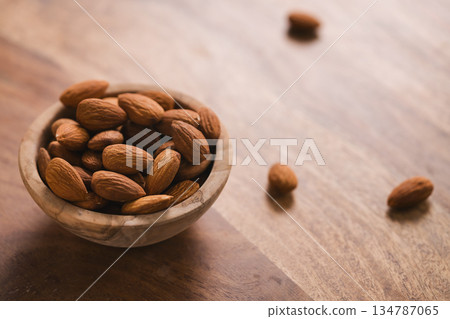peeled almonds in wood bowl 134787065