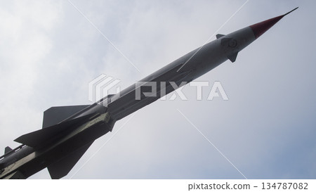 tall surface-to-air missile pointed skyward with black and red nose, museum pedestal base and dramatic tall surface-to-air missile pointed skyward with black and red nose, museum pedestal base and dramatic 134787082