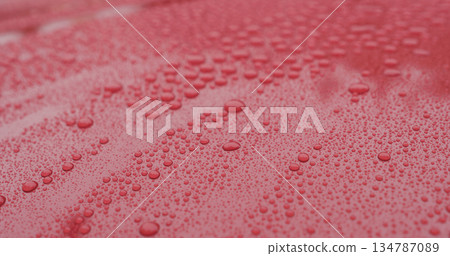 closeup of raindrops on ceramic coated red car with hydrophobic effect 134787089