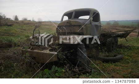 old military truck left behind, weathered military pickup surrounded by overgrown grass and distant horizon, dilapidated wartime truck resting in field amid tall grass and fading sky old military truck left behind, weathered military pickup surrounded by overgrown grass and distant horizon, dilapidated wartime truck resting in field amid tall grass and fading sky 134787098