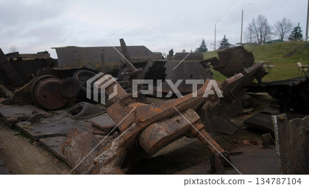 chaotic arrangement of automotive remnants amid weathered surroundings, dispersed metallic remains and framework fragments under overcast sky evoke industrial decline and wartime abandonment chaotic arrangement of automotive remnants amid weathered surroundings, dispersed metallic remains and framework fragments under overcast sky evoke industrial decline and wartime abandonment 134787104