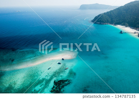 View from the height of the sandy spit with clear blue water, boats and tourists. Redang Island. Malaysia 134787135