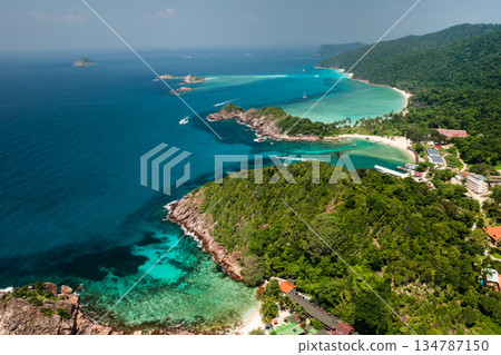 Beautiful view from the height of the tropical beach of Redang Island with clear turquoise waters and lush green hills on a sunny day. Malaysia Beautiful view from the height of the tropical beach of Redang Island with clear turquoise waters and lush green hills on a sunny day. Malaysia 134787150