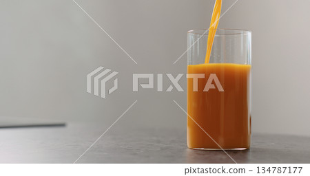 sea buckthorn juice pour into beaker glass on concrete surface sea buckthorn juice pour into beaker glass on concrete surface 134787177