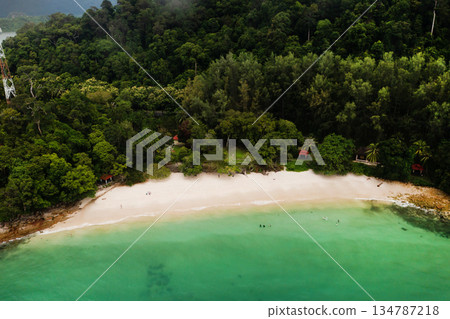 Aerial view of Tropical Skulls Beach on Langkawi Island with lush green hills and serene coastal scenery. Malaysia 134787218
