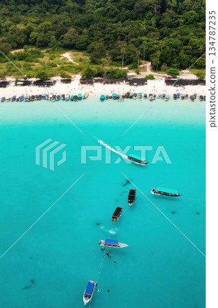 Bird's eye view of Redang Island with a tropical beach and tourist boats off the coast Bird's eye view of Redang Island with a tropical beach and tourist boats off the coast 134787235