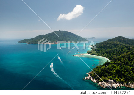 Stunning aerial view of the Perhentian Islands with lush greenery and coral reef on a bright sunny day. Malaysia Stunning aerial view of the Perhentian Islands with lush greenery and coral reef on a bright sunny day. Malaysia 134787255