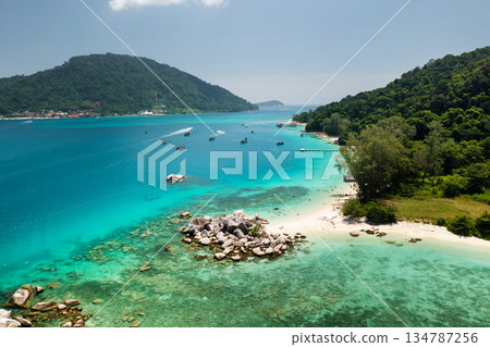 Breathtaking view of a secluded beach with crystal clear waters and rocky formations on the Perhentian islands. Malaysia 134787256