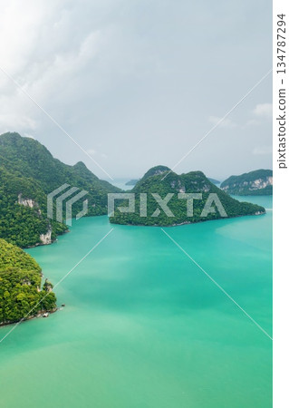 Stunning aerial view of emerald waters and lush islands in a tropical paradise at KILIM Geopark on Langkawi Island. Malaysia Stunning aerial view of emerald waters and lush islands in a tropical paradise at KILIM Geopark on Langkawi Island. Malaysia 134787294