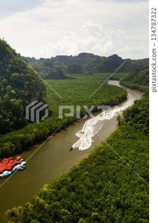 Aerial view of the fish farm in Kilim Geopark, surrounded by lush green mountains, with boats, Langkawi Island. Malaysia Aerial view of the fish farm in Kilim Geopark, surrounded by lush green mountains, with boats, Langkawi Island. Malaysia 134787322