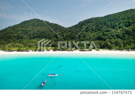 View of the tropical beach on Redang Island. Turtle beach with tourists and boats on Redang Island in Malaysia View of the tropical beach on Redang Island. Turtle beach with tourists and boats on Redang Island in Malaysia 134787473
