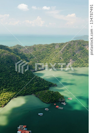 Scenic aerial view of the green mountains and river in KILIM Park on a sunny day with a clear sky. Langkawi. Malaysia 134787491